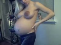 Young pregnant blonde flaunting her round tummy and bouncy boobs on cam